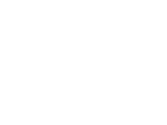 A pair of stylish, dark sunglasses with gradient lenses resting on a wooden surface, partially lit by sunlight.