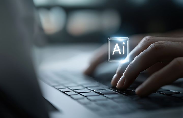 Person typing on laptop, glowing 