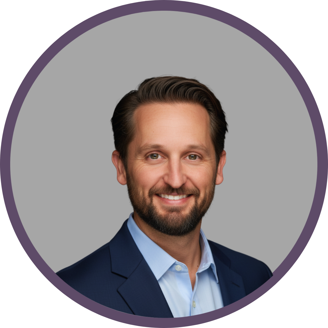 Man in a blue suit and light blue shirt smiles at the camera, inside a purple circle.