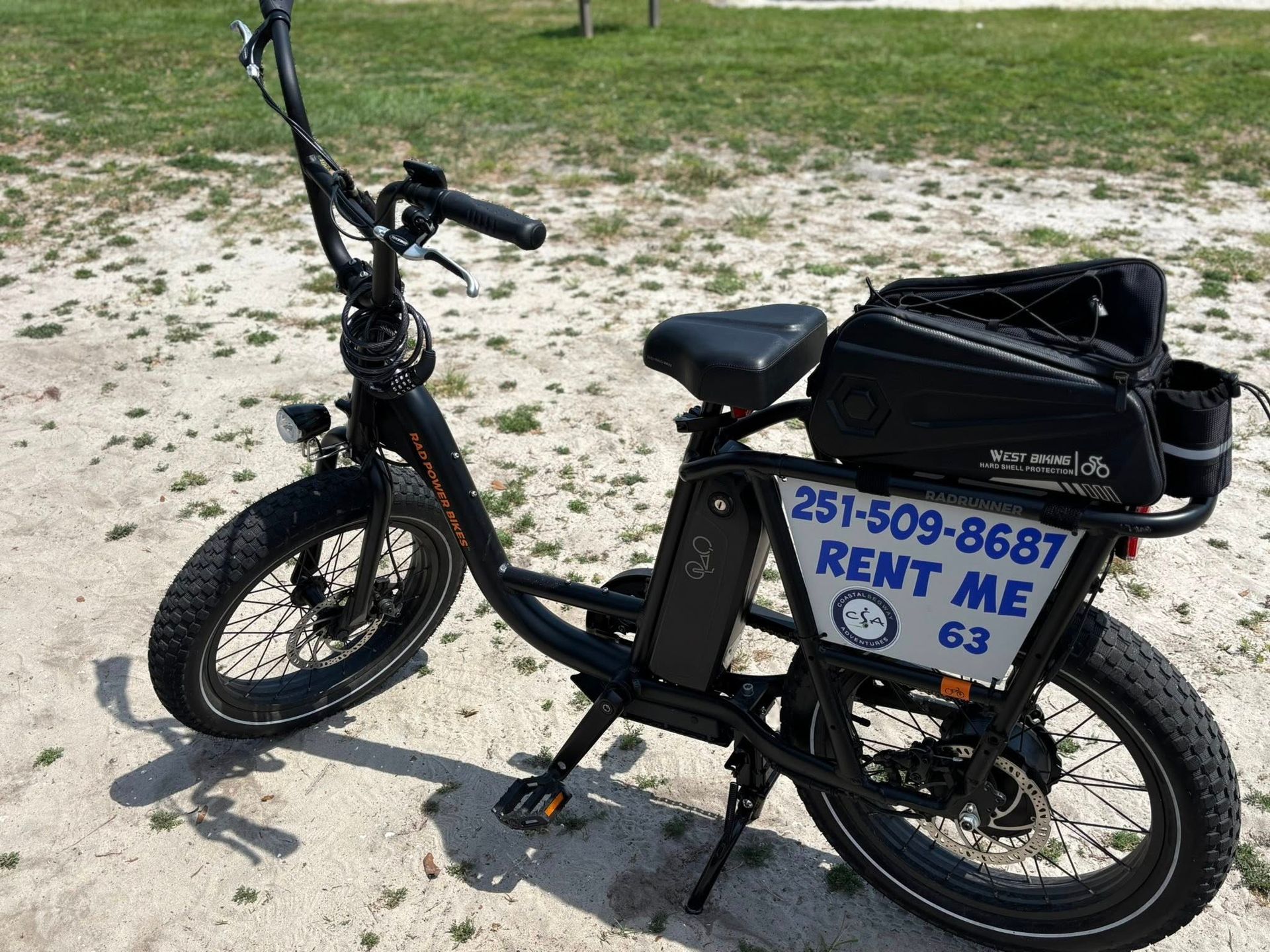 Black electric bicycle on a sandy surface with