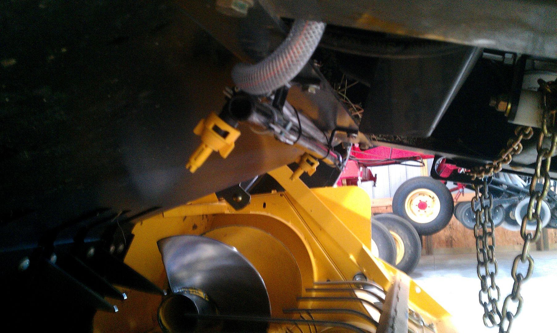 A yellow tractor with a chain attached to it