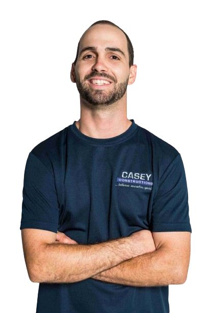 A man with a beard is wearing a blue casey shirt