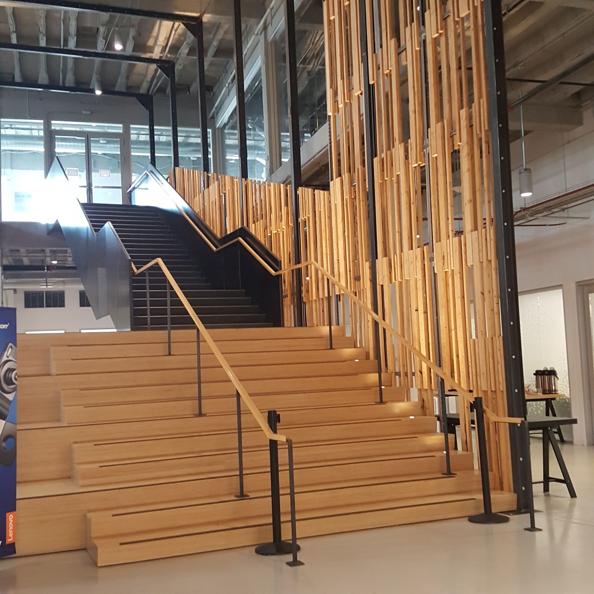 A staircase with a wooden railing in a building