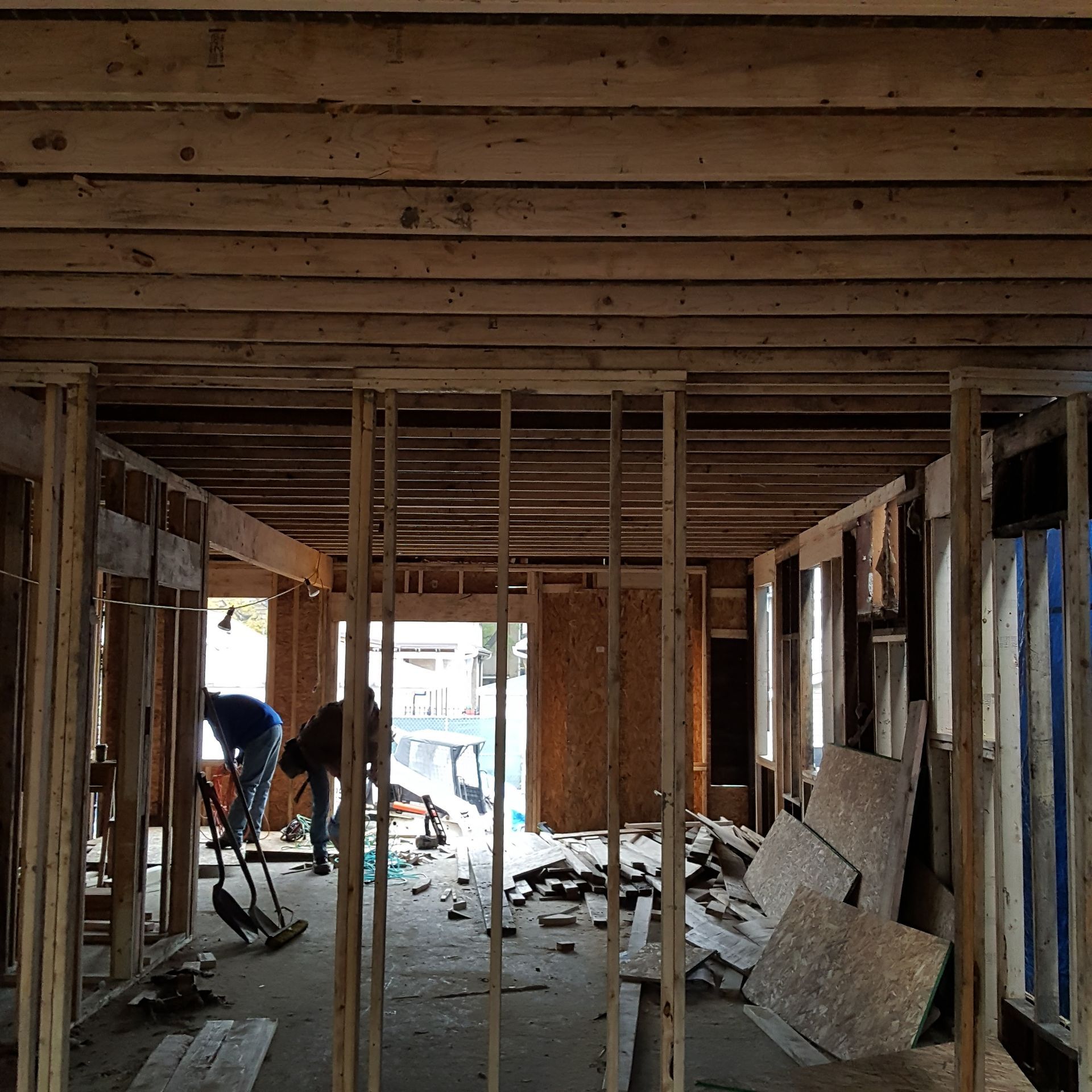 A man is standing in the middle of a building under construction