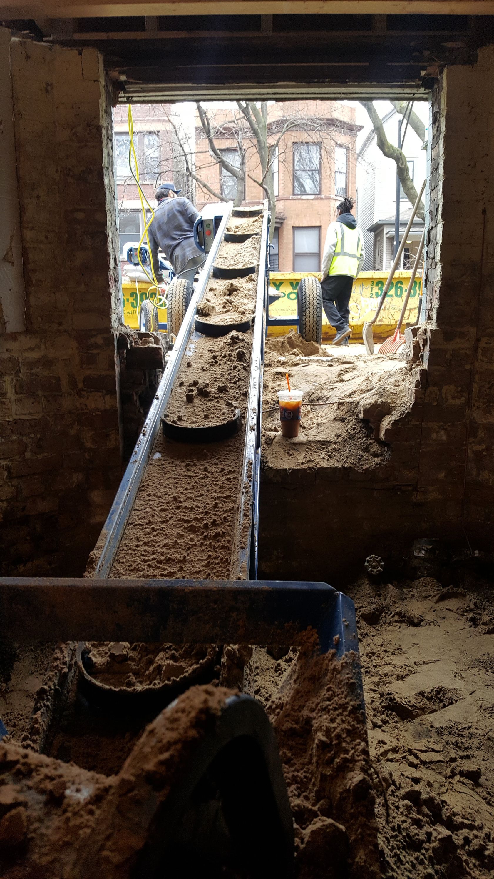 A group of construction workers are working on a building.