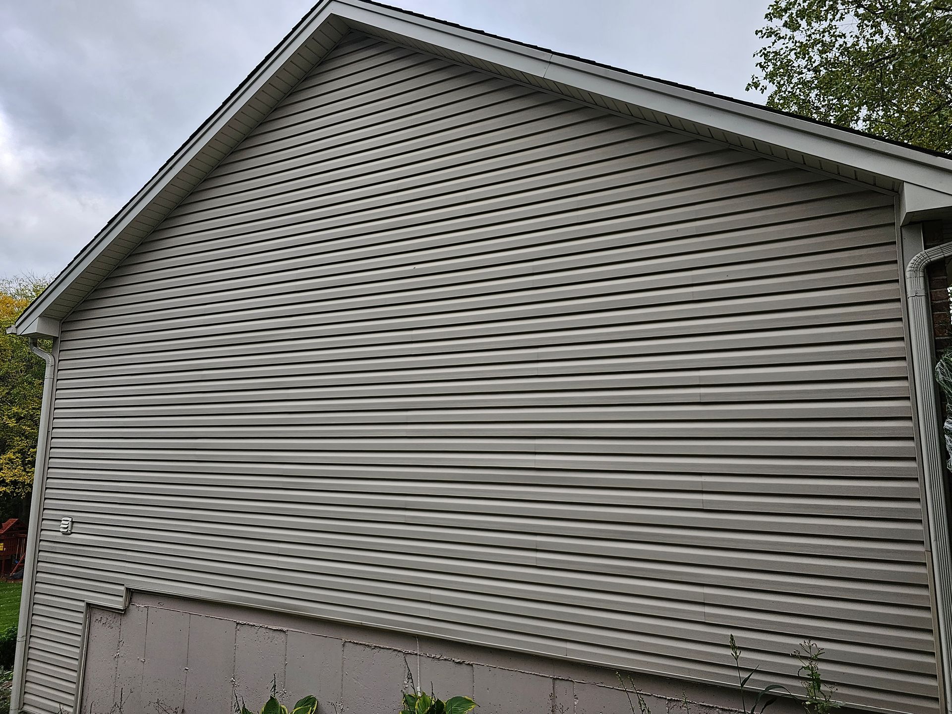 A house with a white siding and a white roof