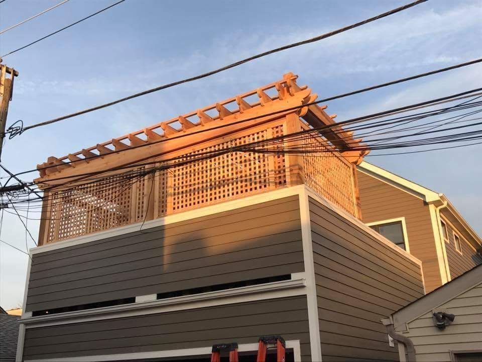 A house with a wooden balcony on top of it