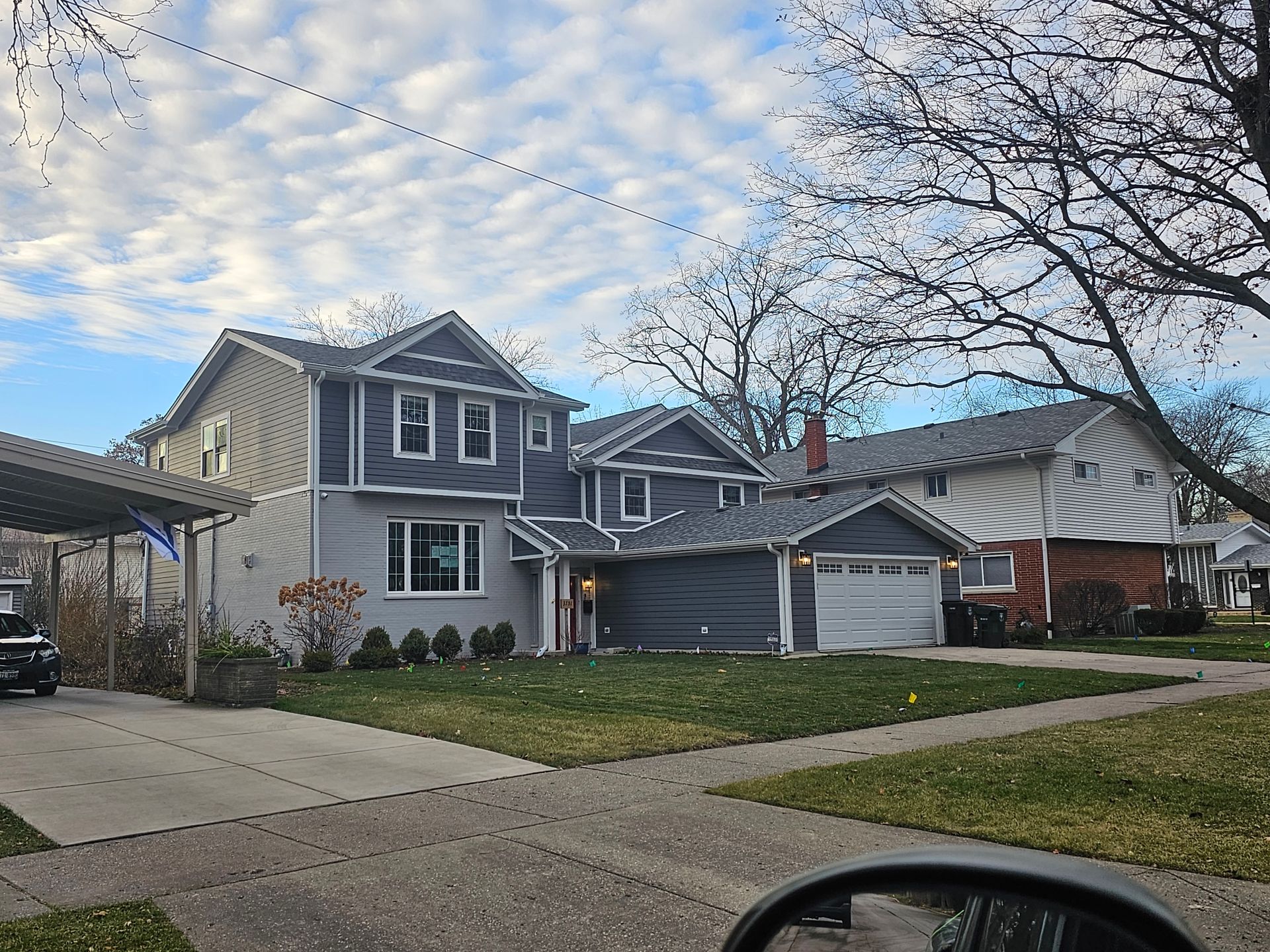 A house with a car parked in front of it