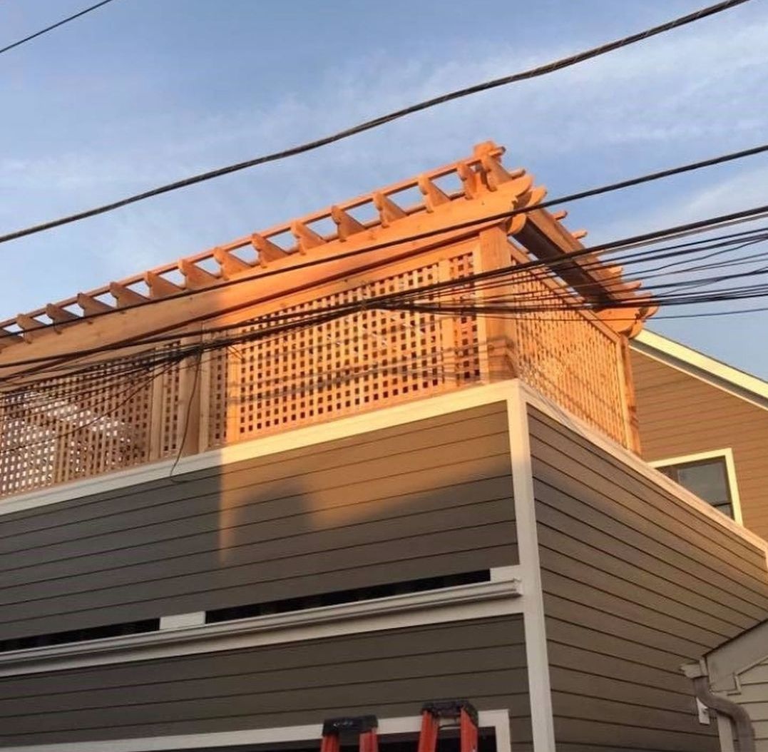 A house with a wooden pergola on top of it