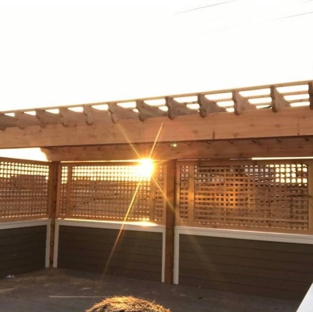 The sun is shining through a wooden structure