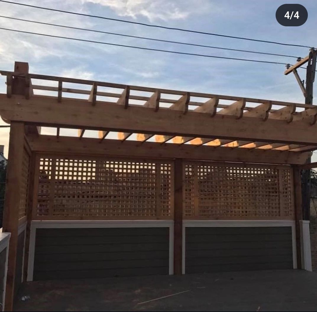 A picture of a wooden pergola over two garage doors