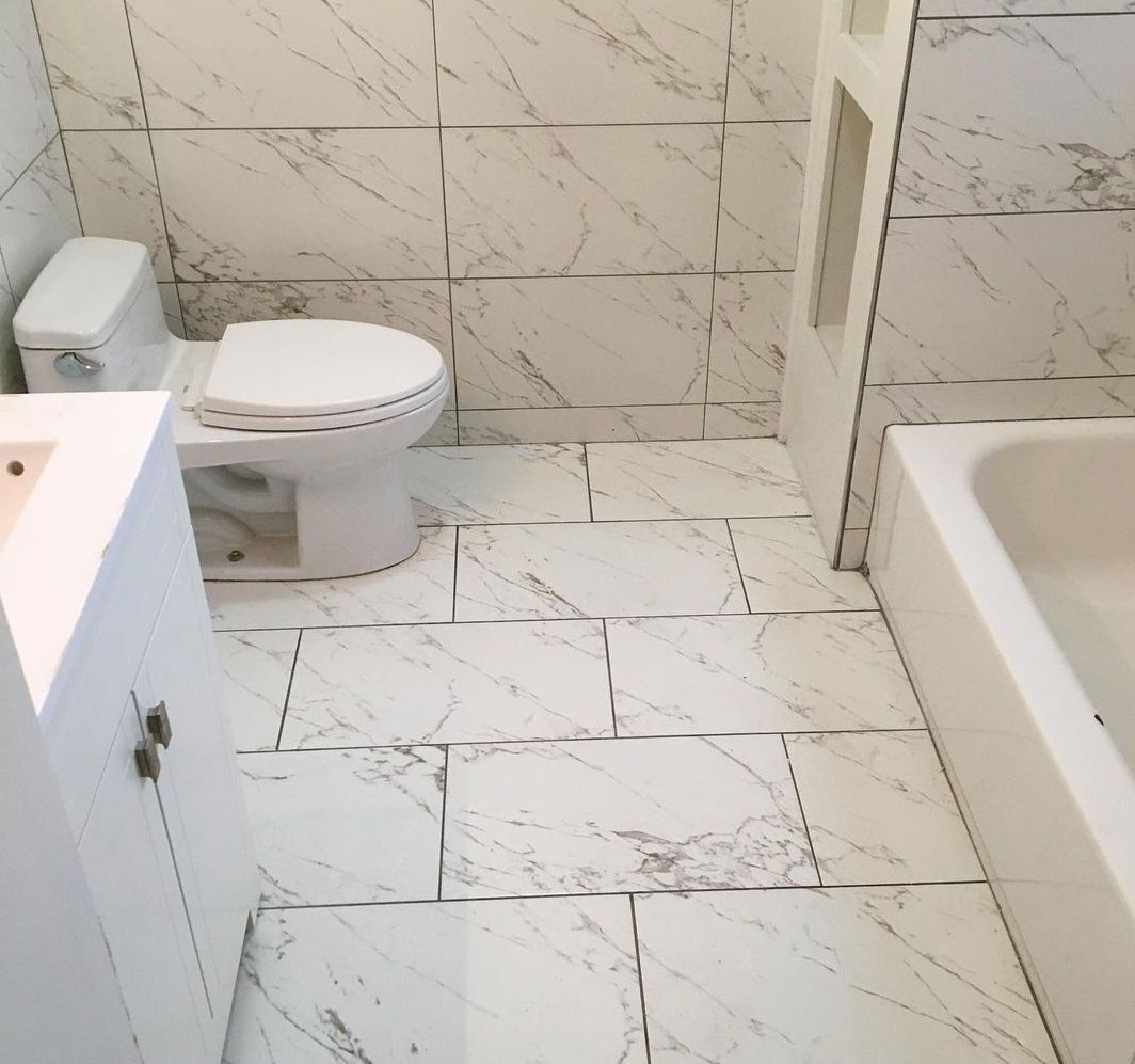 A bathroom with a toilet a sink and a bathtub