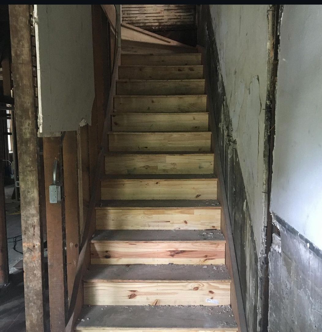 A set of wooden stairs leading up to the second floor