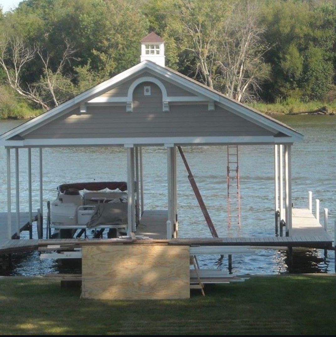 A boat dock with a roof that says ' a ' on it