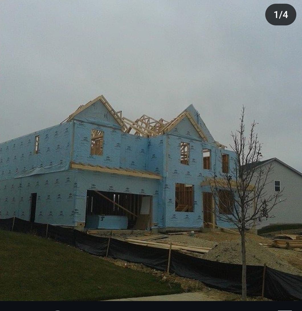 A blue house is being built with the number 1/4 in the corner