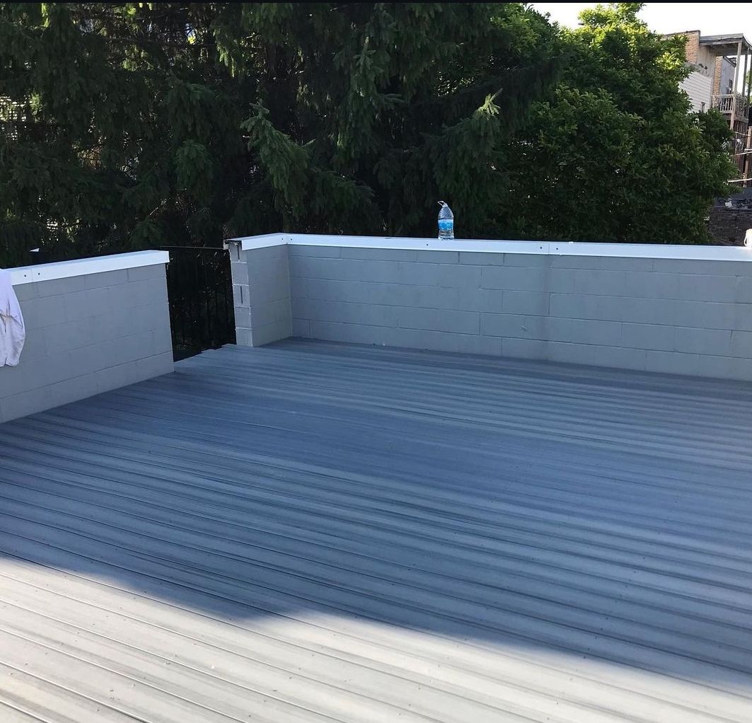 A rooftop deck with a bottle of water on it