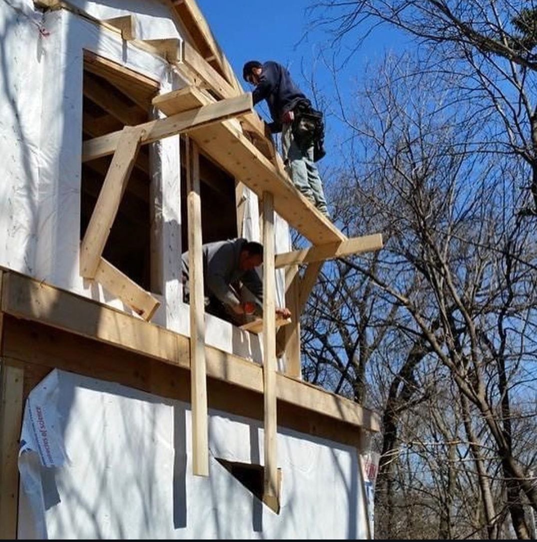 Two men are working on the roof of a building