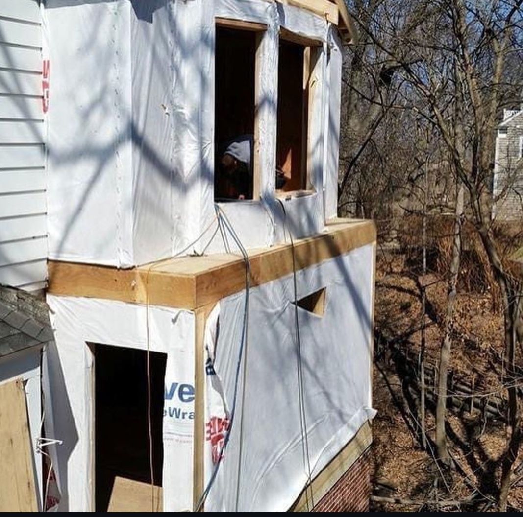 A house that is being built with a roof that says ' evaporative ' on it
