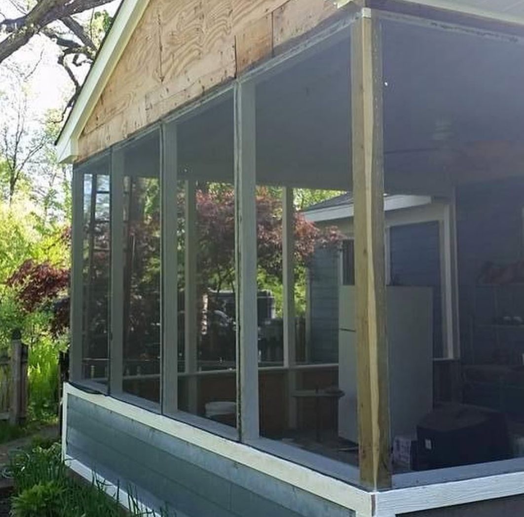 A screened in porch with a lot of windows