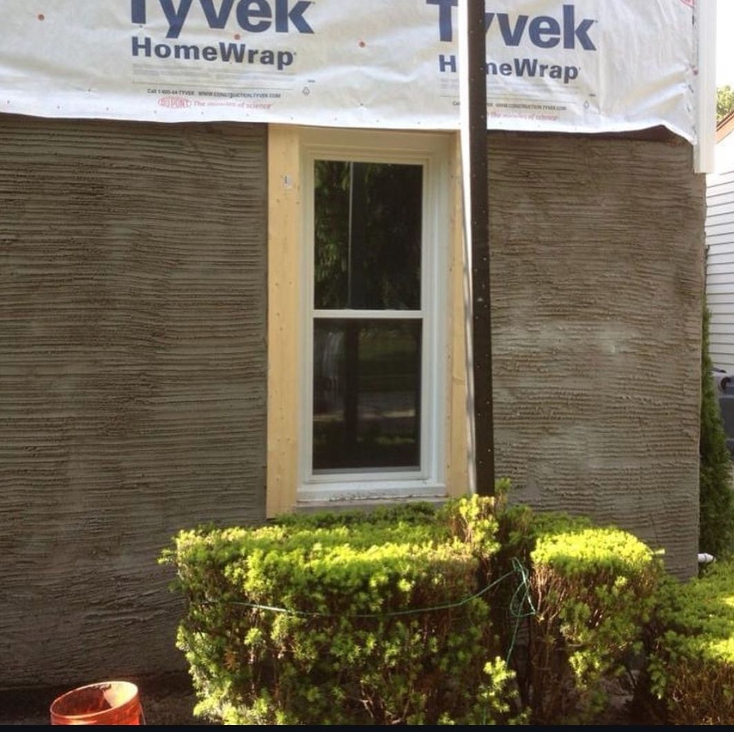 A building with a window and a sign that says tyvek homewrap