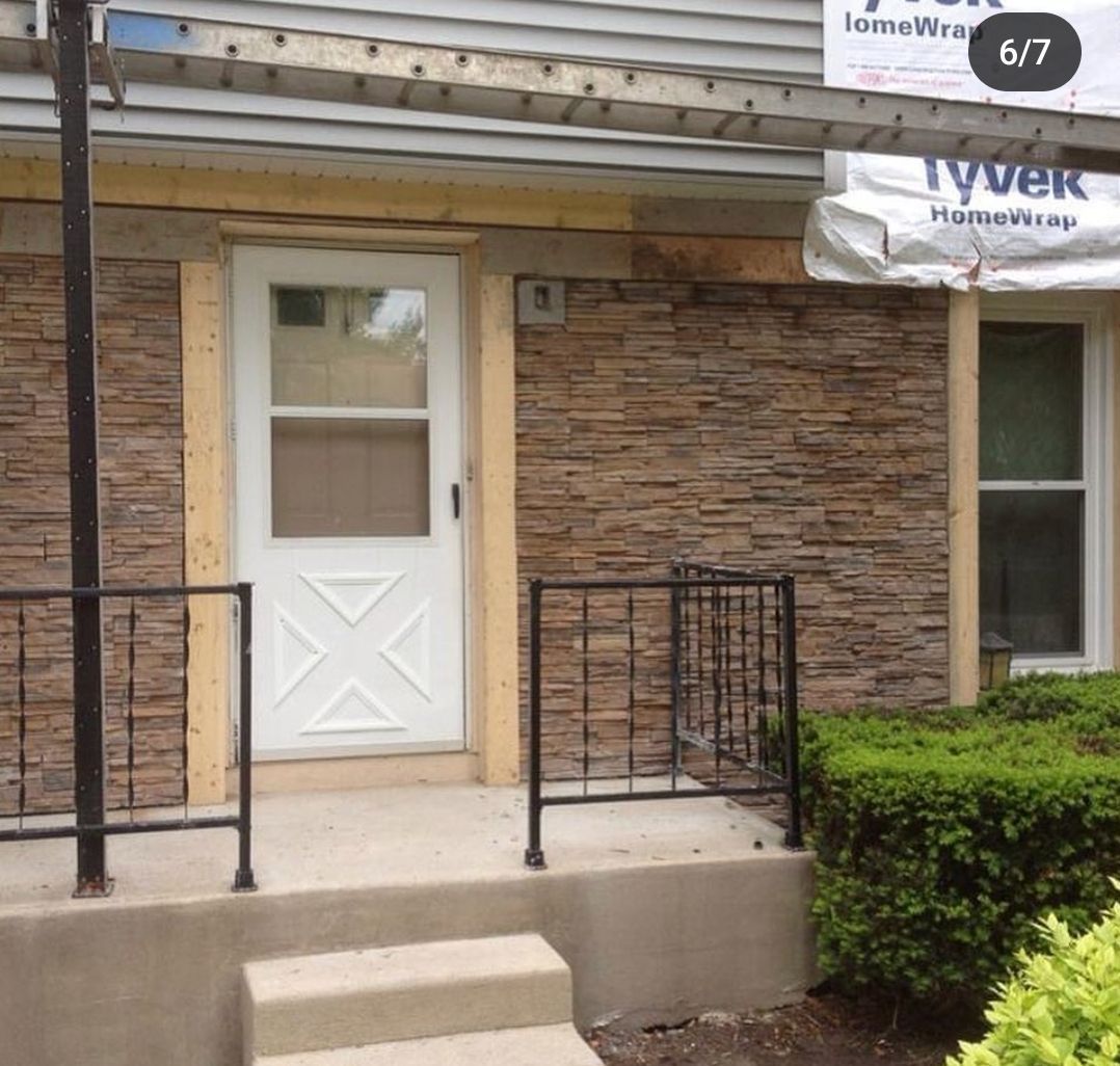 A brick building with a white door and a sign that says homewire