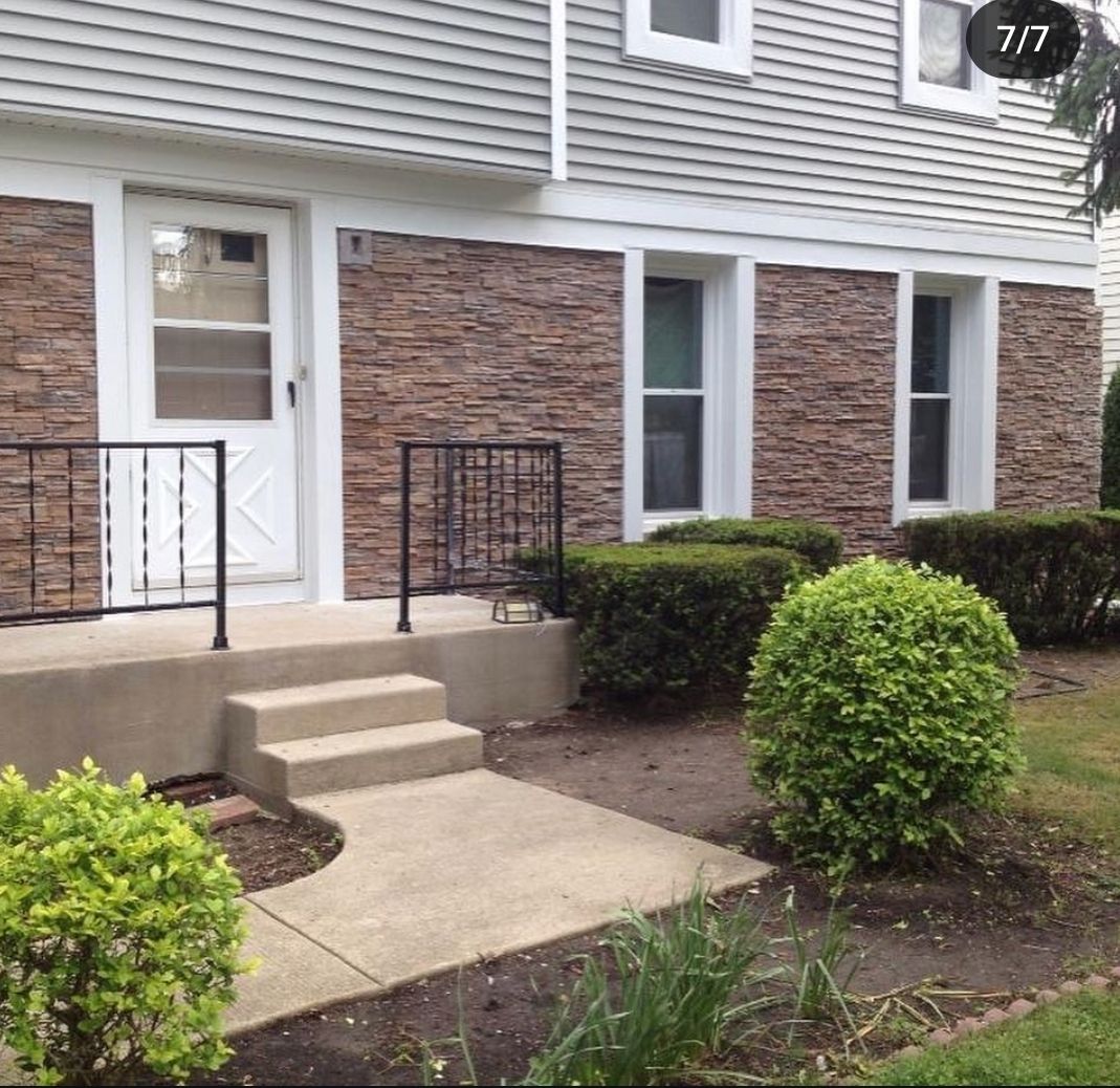 A house with a brick facade and a white door