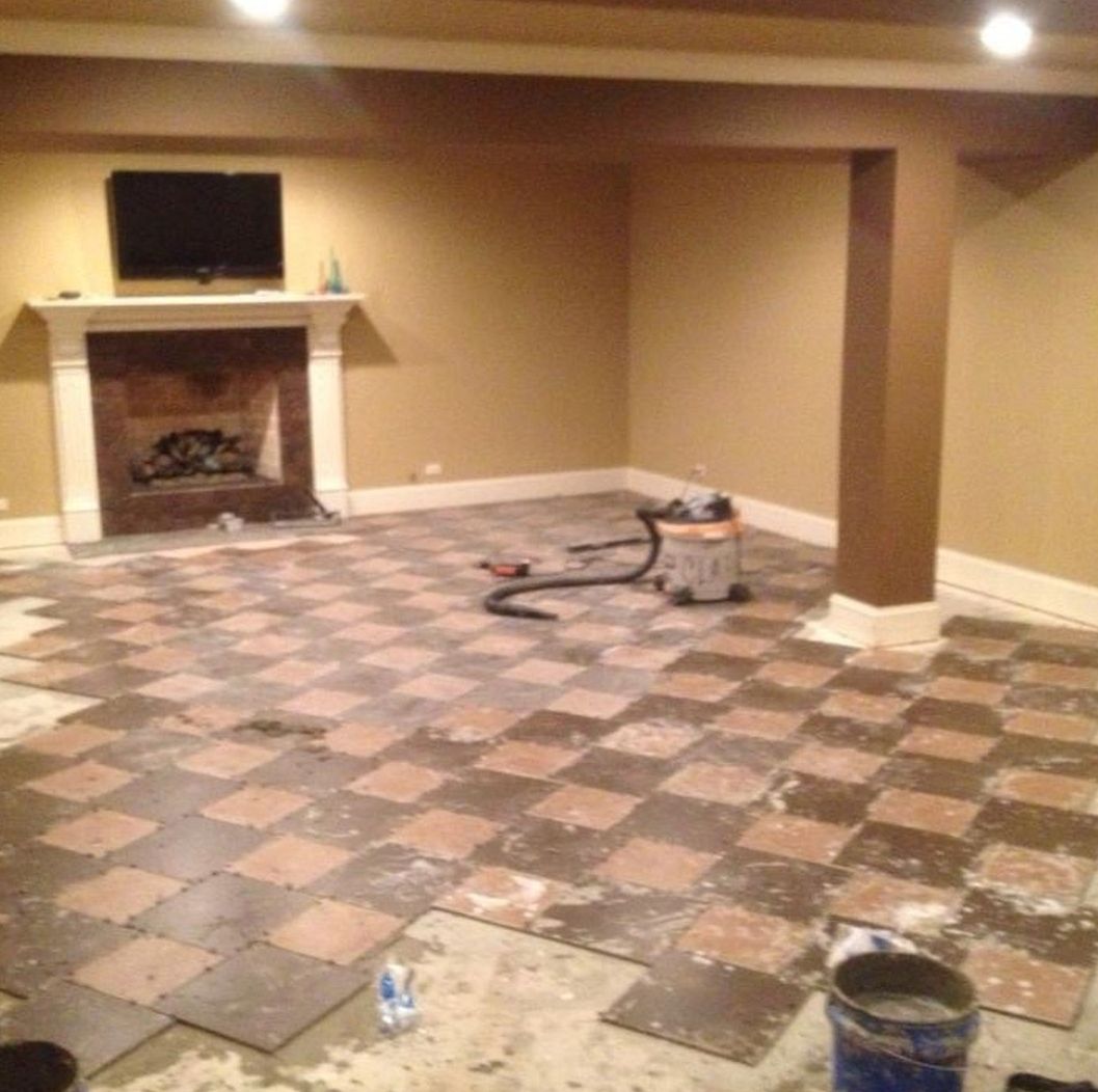 A room with a checkered floor and a fireplace