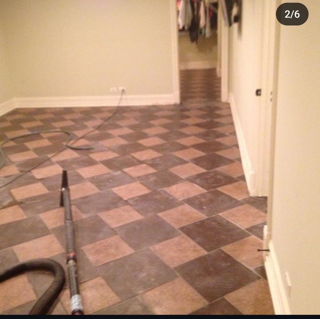 A vacuum cleaner is sitting on a checkered floor