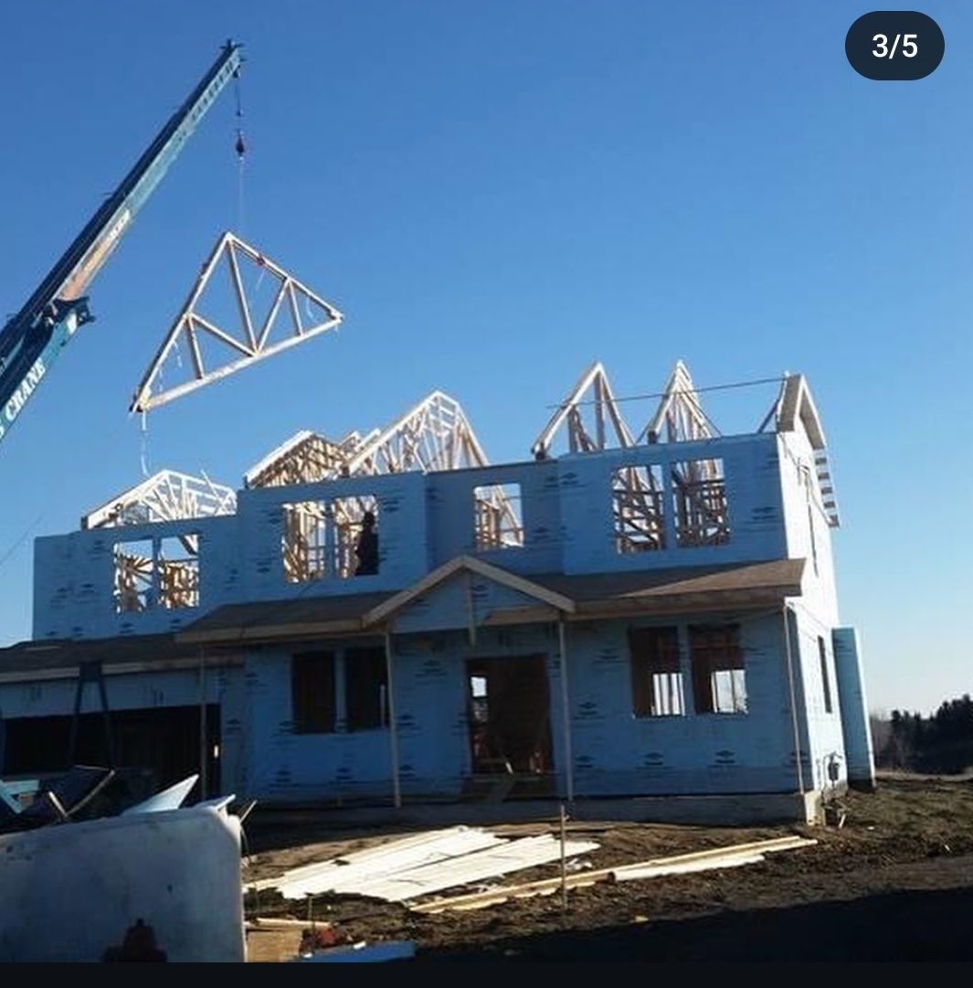 A house is being built with a crane in the background