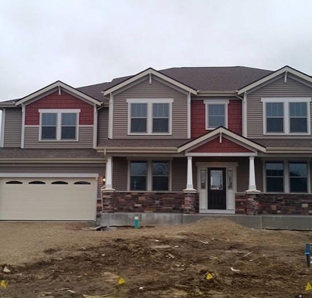 A large house with a lot of windows and a garage