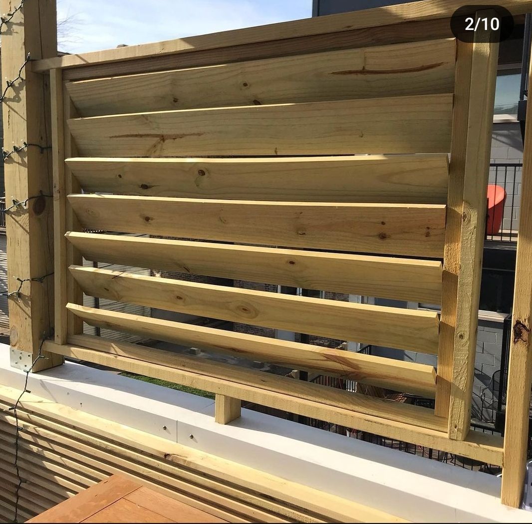 A wooden fence is sitting on top of a balcony.