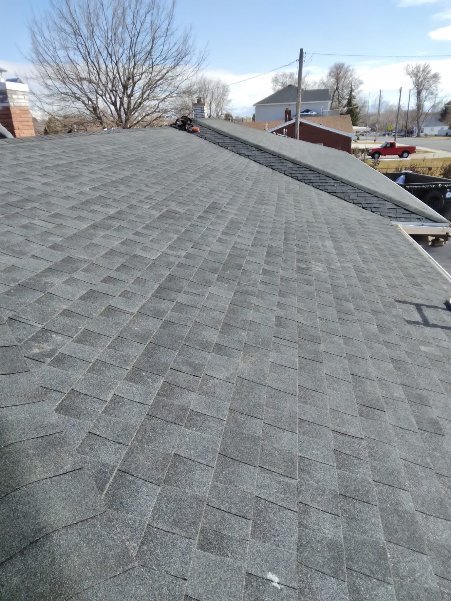 A close up of a roof with a lot of shingles on it.