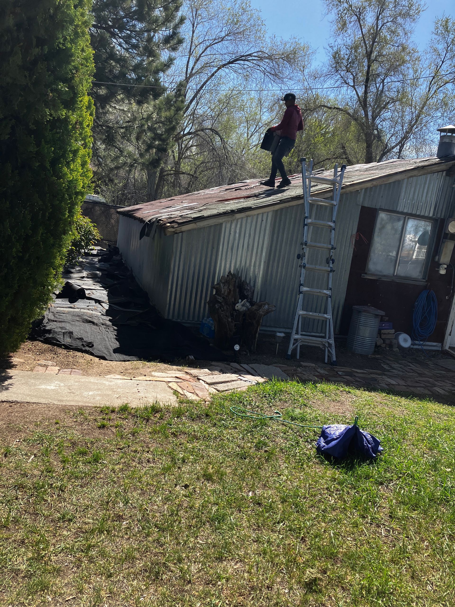 A man is standing on the roof of a trailer.