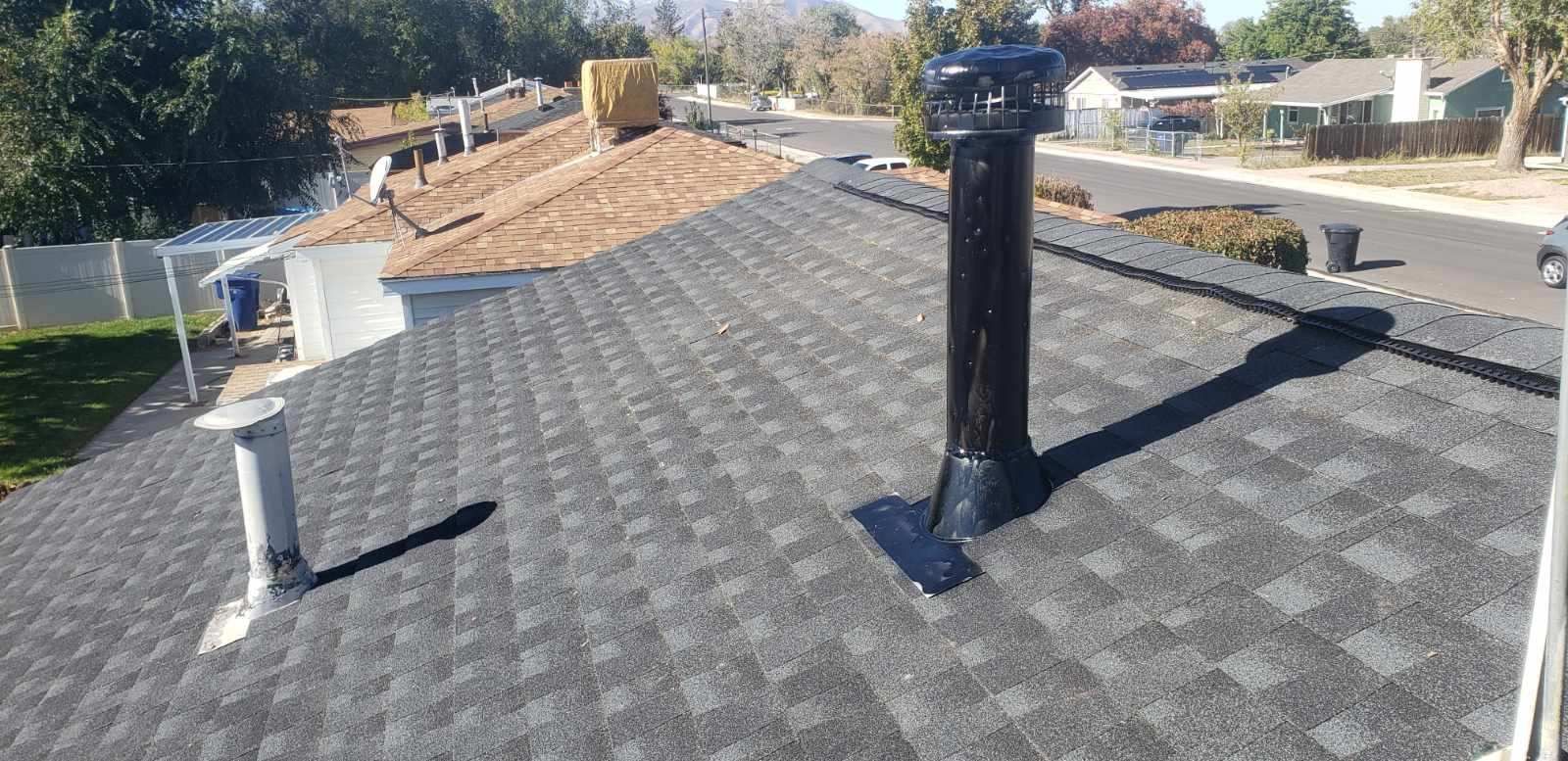 There is a chimney on the roof of a house.
