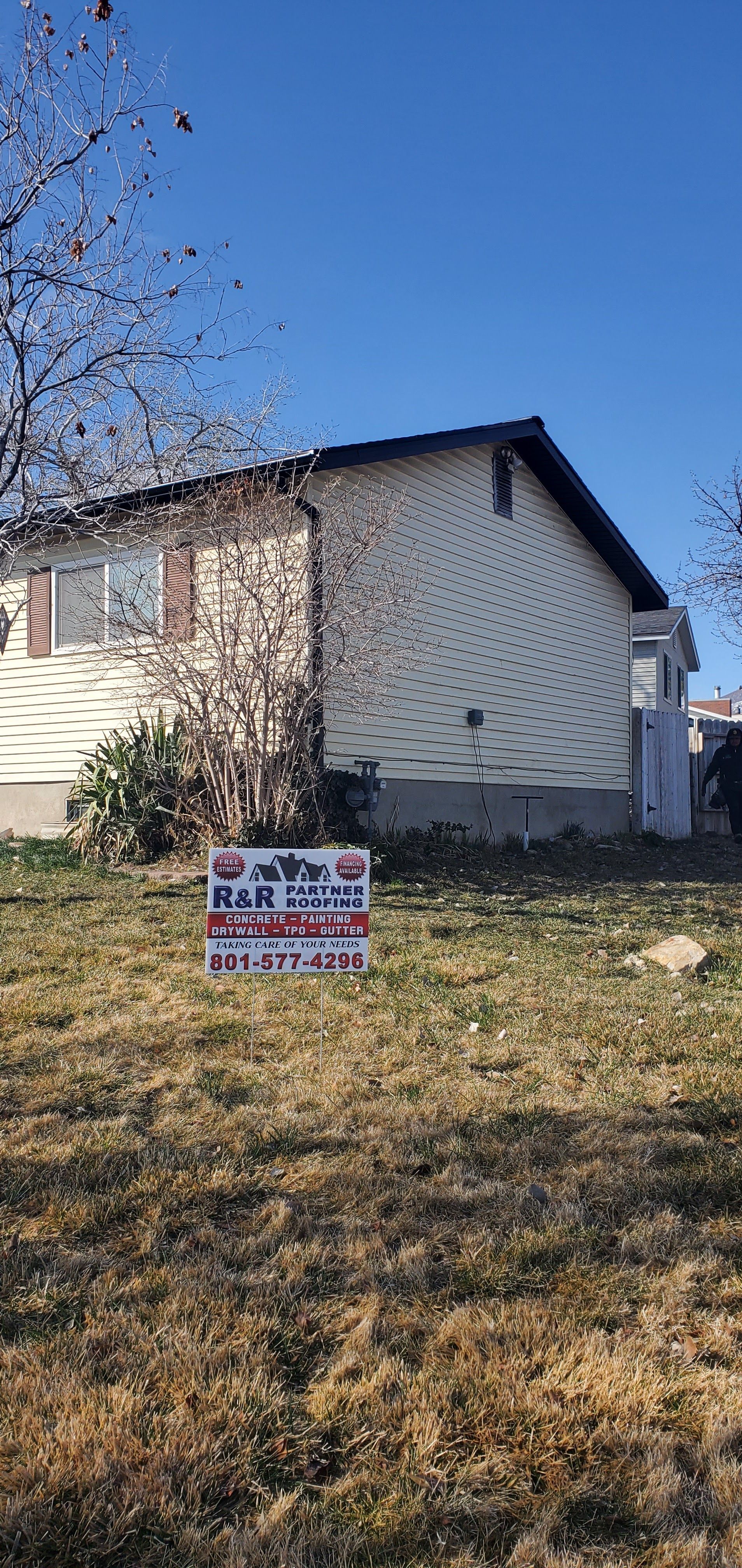 A house with a for sale sign in front of it.