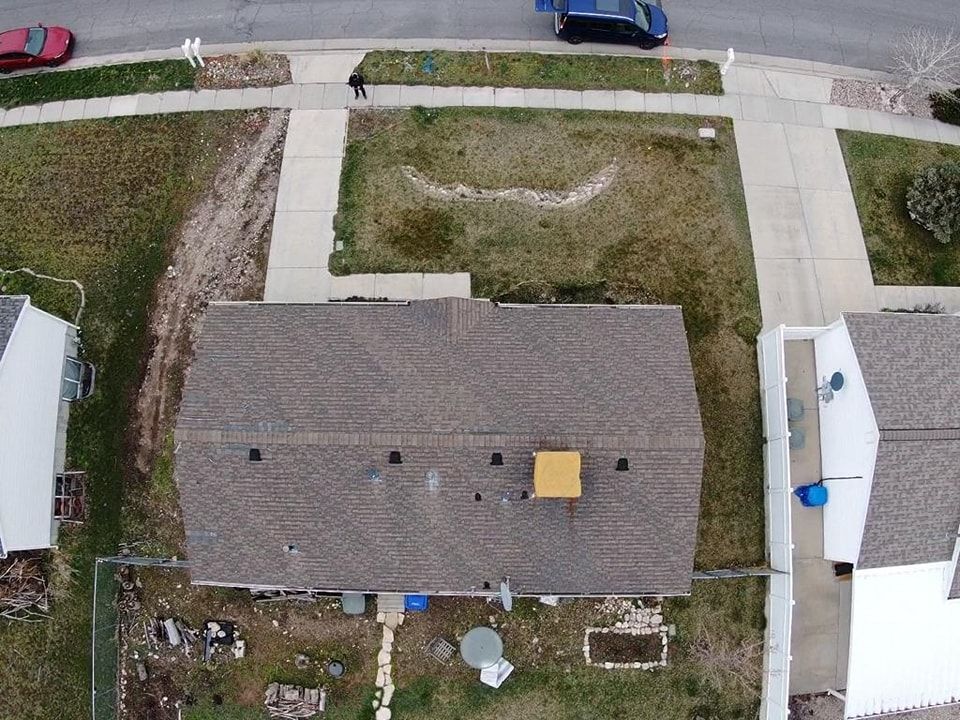 An aerial view of a house with a smiley face on the roof