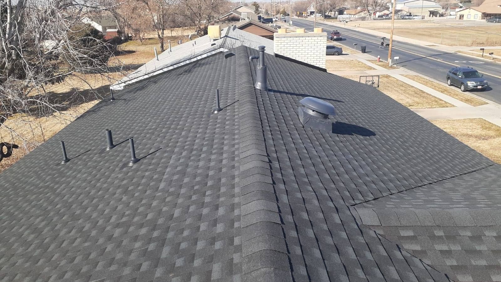 A close up of a roof with a chimney on top of it.