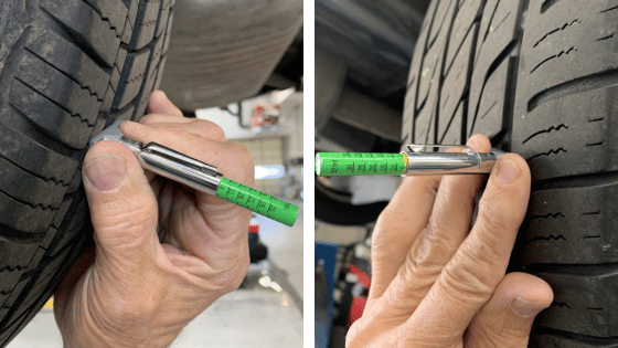 Hand checking tire tread depth with a green gauge on a car tire, close-up view.