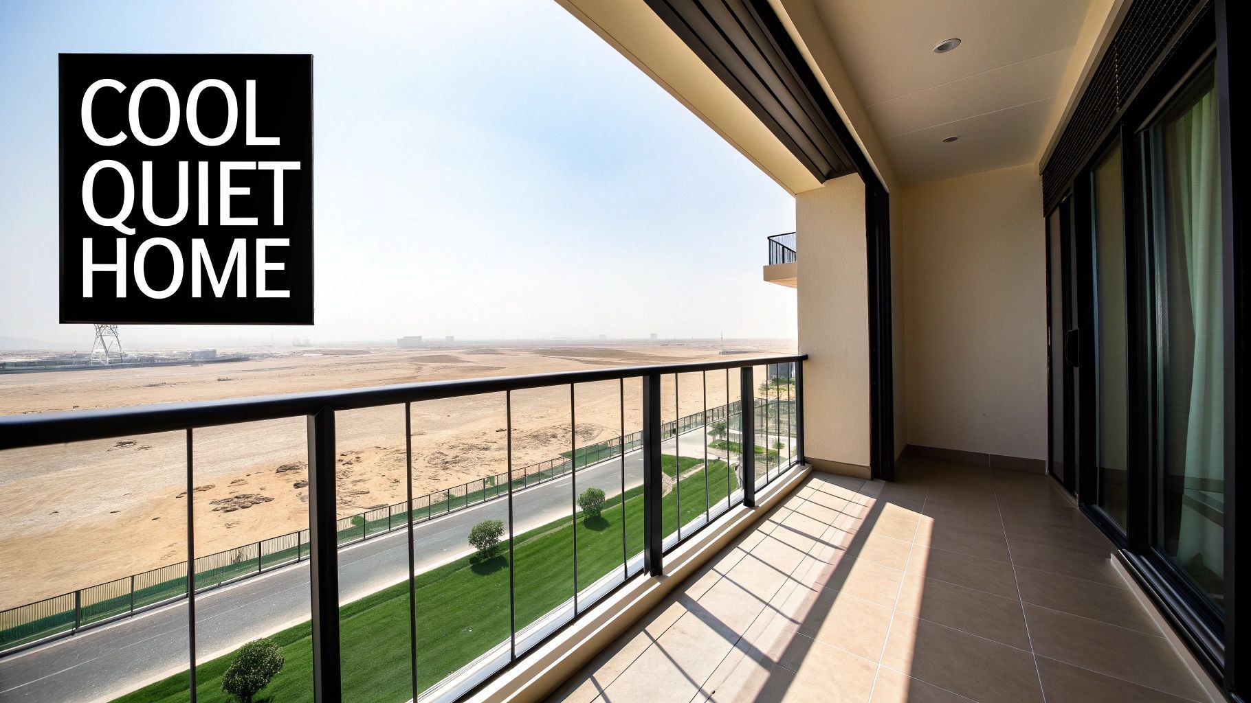 Balcony with black railing and glass overlooking a desert landscape. Text overlay: