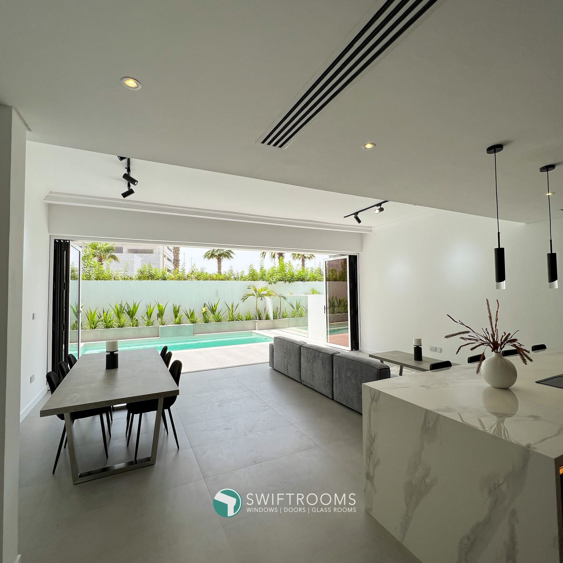 A living room with a table and chairs and a sign that says sweetrooms