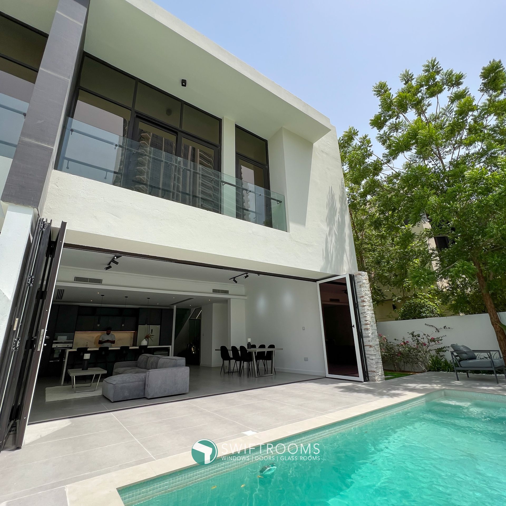 A large house with a swimming pool in front of it