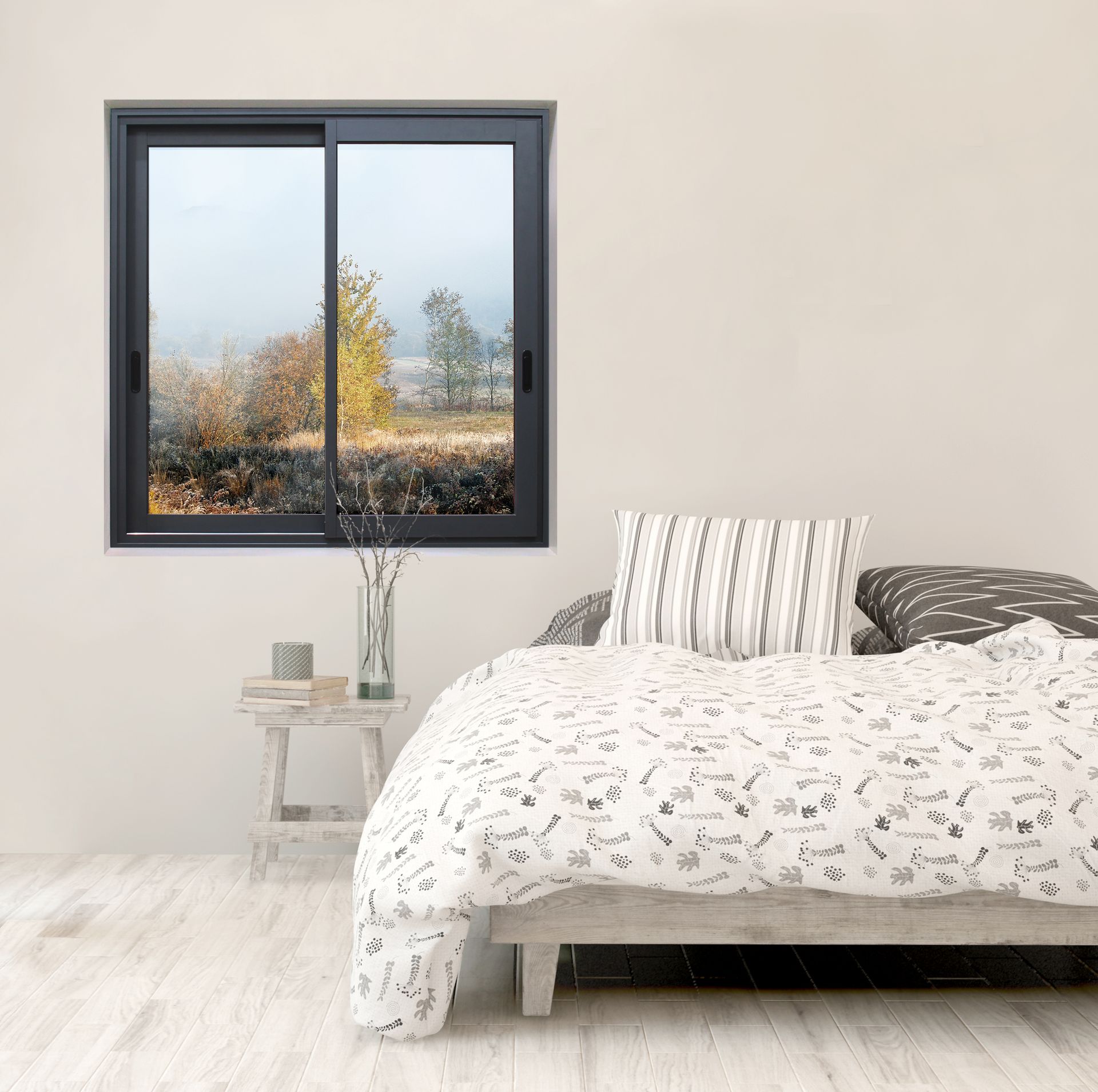 A bedroom with a bed and a window with a view of a field.