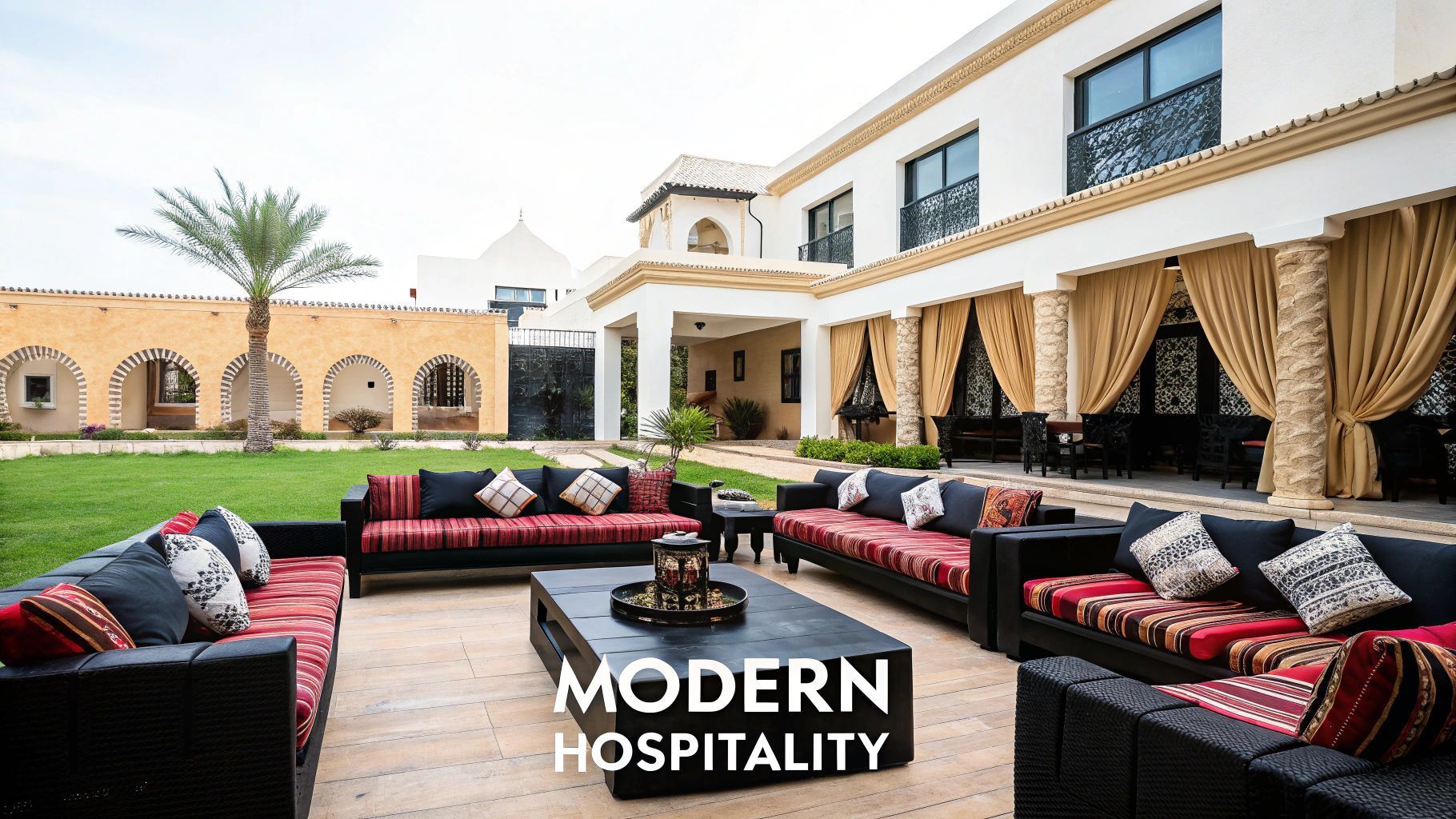 Outdoor patio with couches, in front of a multi-story building. Text:
