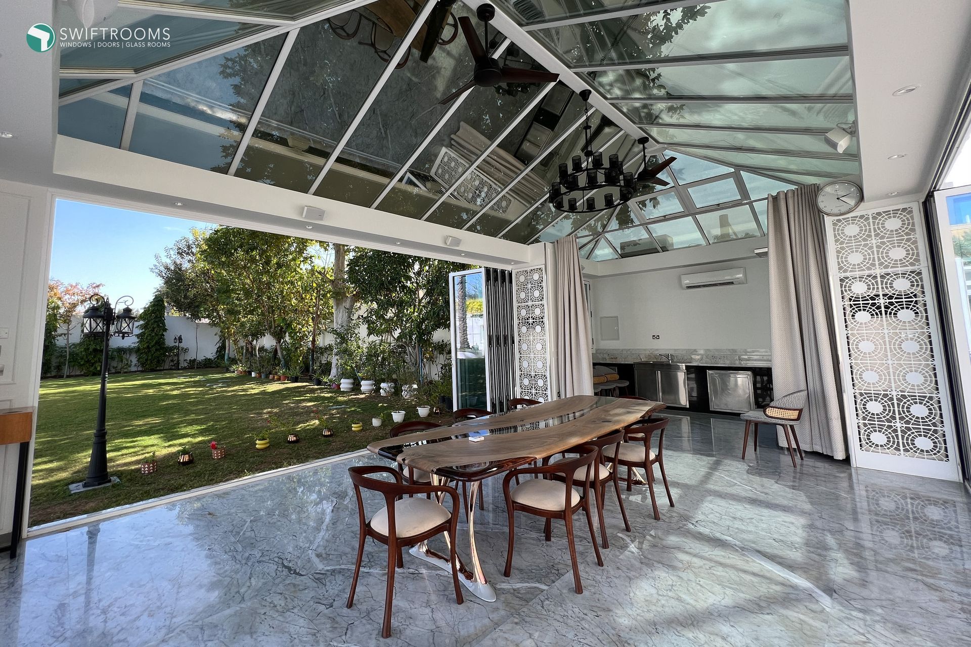 There is a table and chairs in the middle of the room.