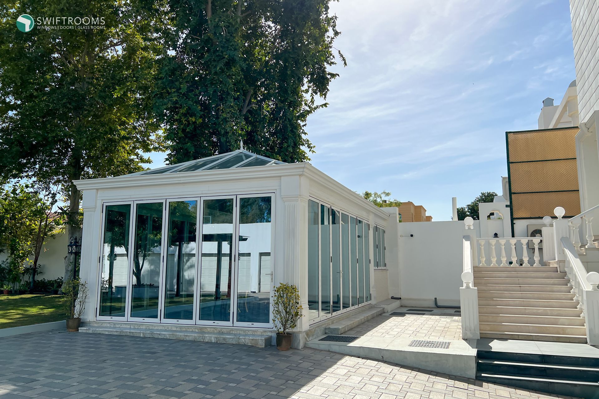 A white building with a lot of windows and stairs