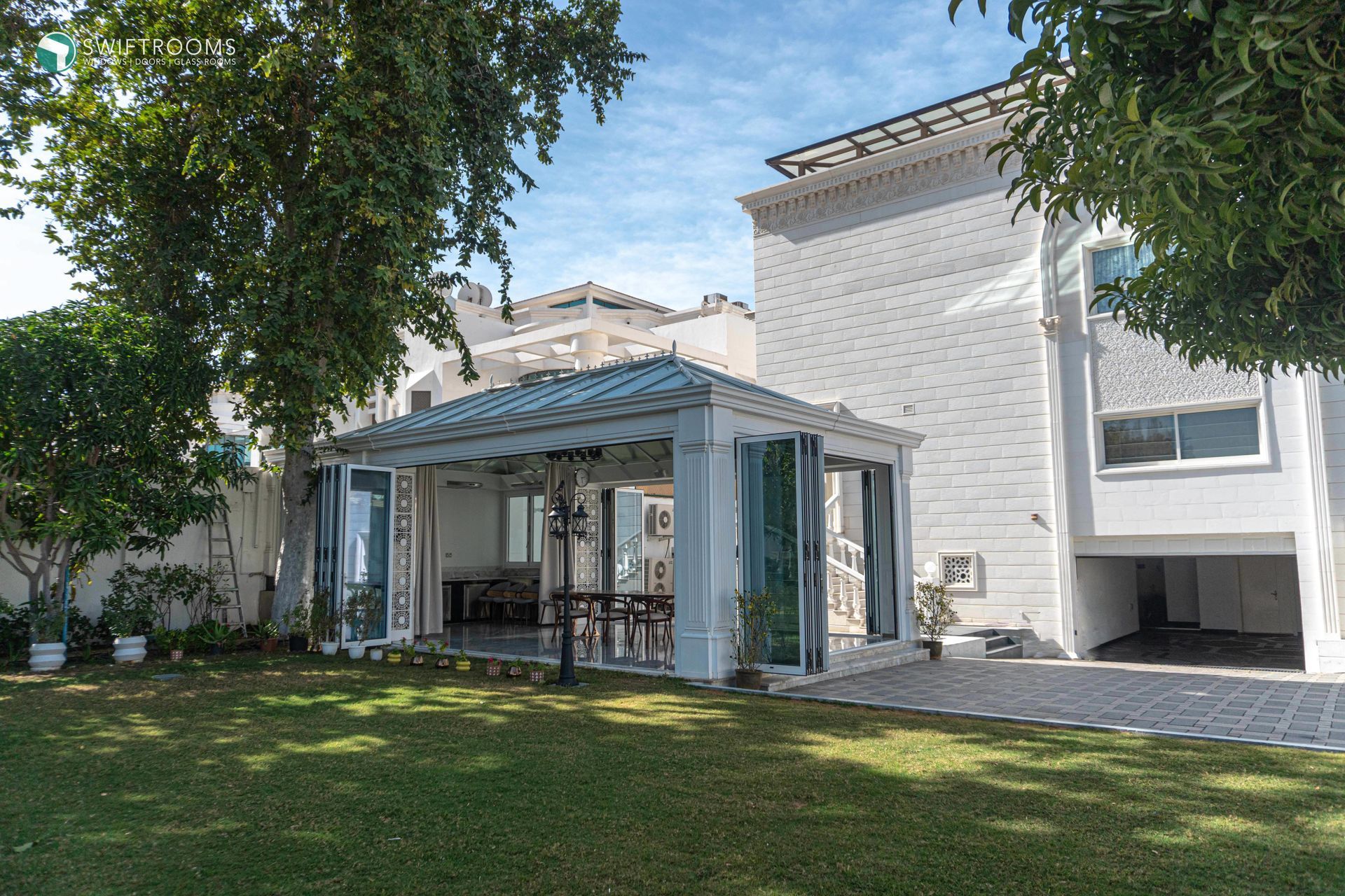 A large white house with a large lawn in front of it.