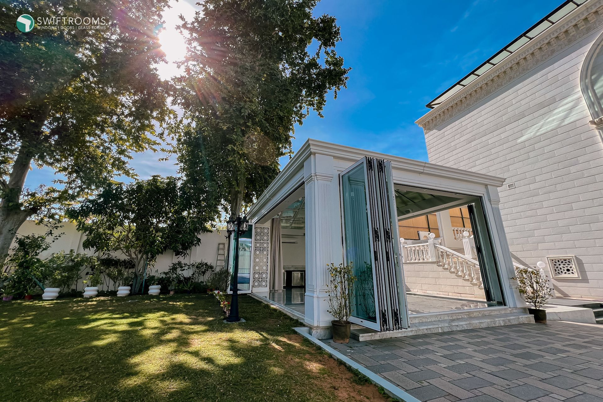 A large white house with a gazebo in front of it