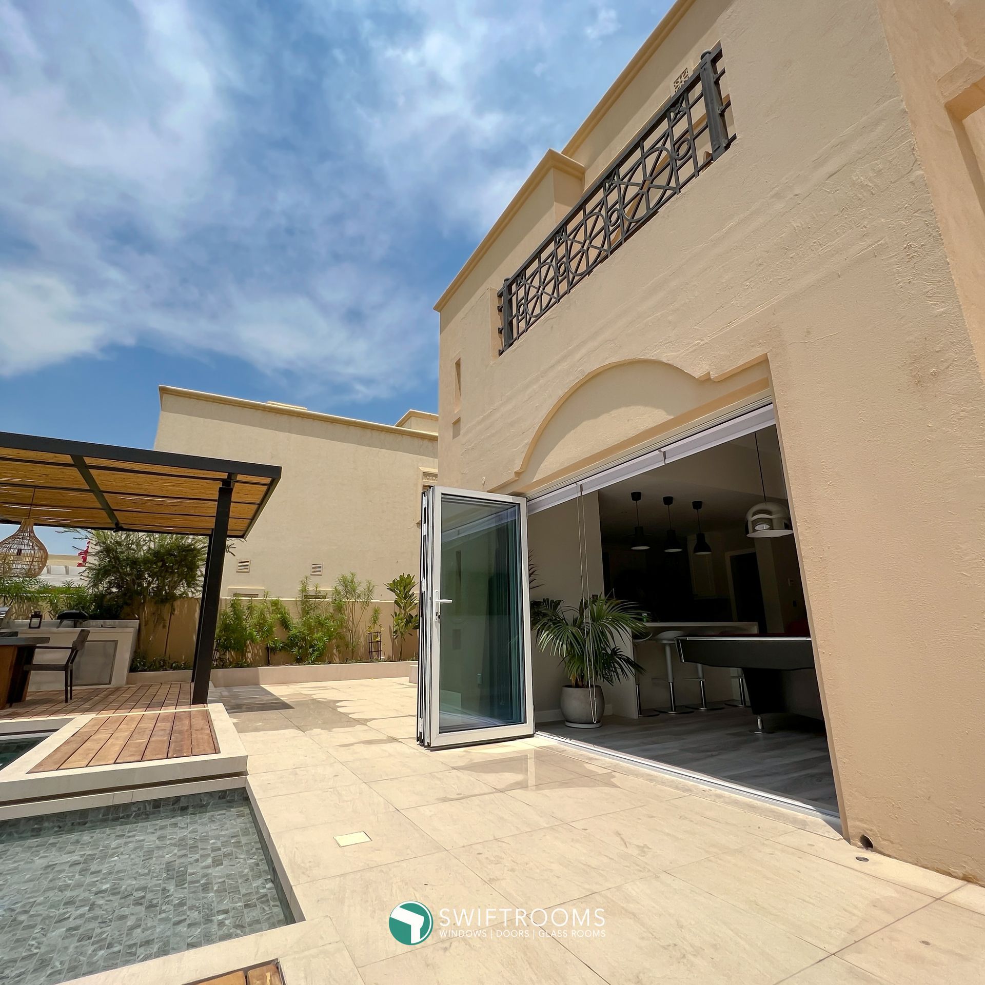 A large house with a pool table and a patio