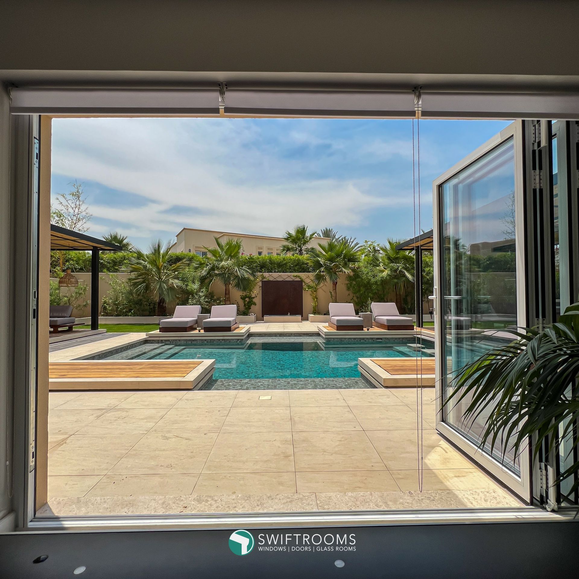 A view of a swimming pool through a glass door