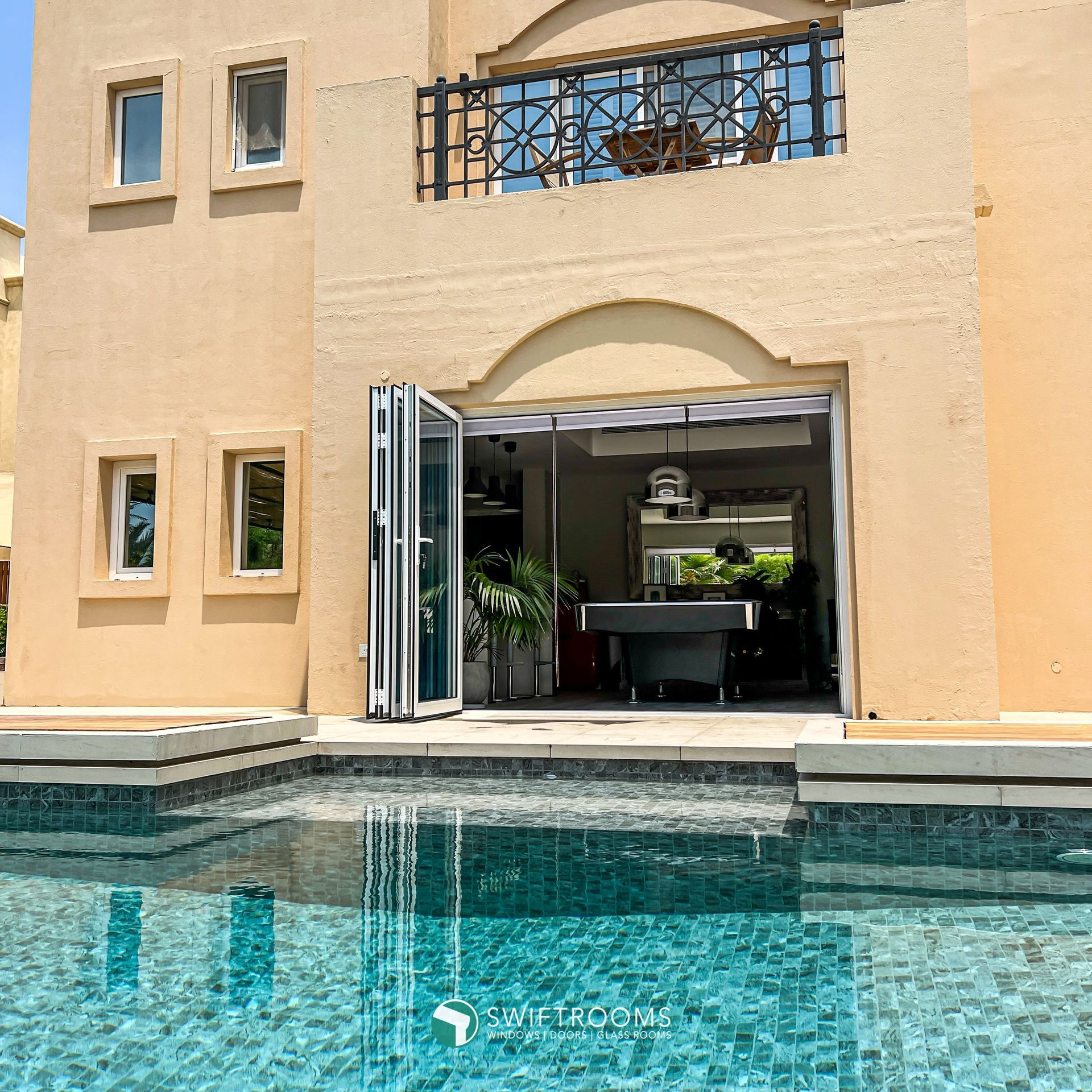 A large house with a pool in front of it